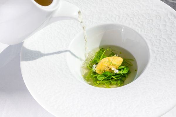 Spring green pea consommé with parsley and sugar snap peas